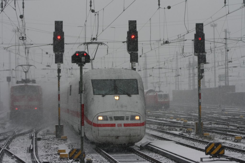 Alle Signale stehen auf Halt als der ICE1 nach Frankfurt Hbf kommt. Die 146 im Hintergrund hatte beide B�gel gehoben und die 111er Sandwich Garnitur nach W�rzburg verschwindet im Schneefall.

Patrick E.